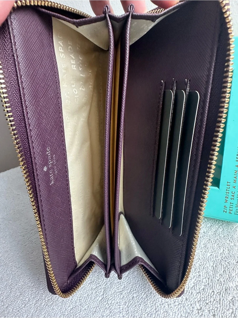 kate spade plum perforated floral zip phone wristlet